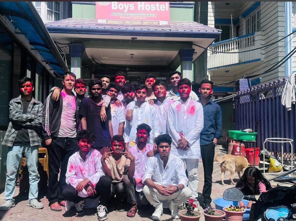 a group of people with paint on their faces posing for a picture at Amazon Boys Hostel in Kathmandu