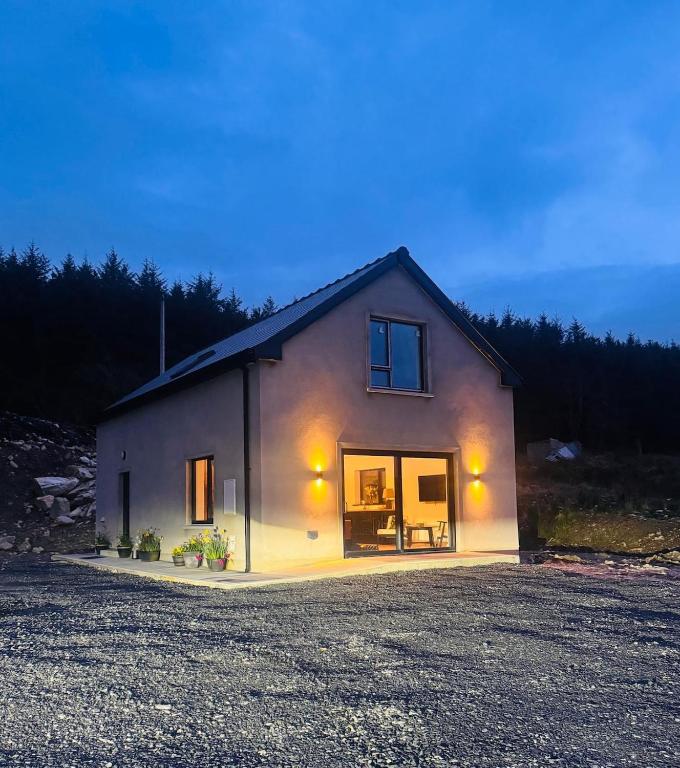 a small house with lights on the side of it at Muckish Hideaway in Crockglass