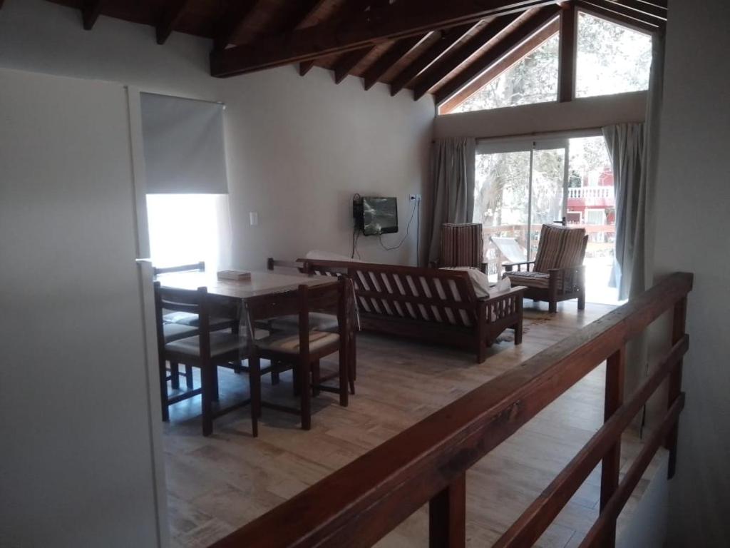 a living room with a wooden table and chairs at Bosque y Mar in Mar Azul