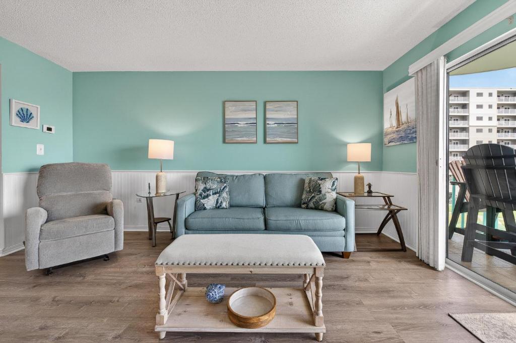 a living room with a couch and a chair at 6405 Gulf Shores Plantation-Palms in Gulf Shores
