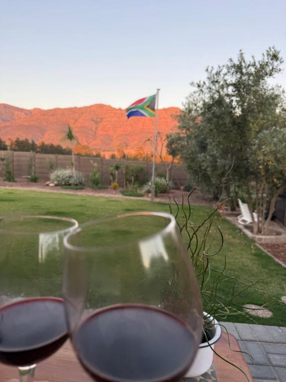 two glasses of wine sitting on a table with a flag at Glorious Stay in Porterville