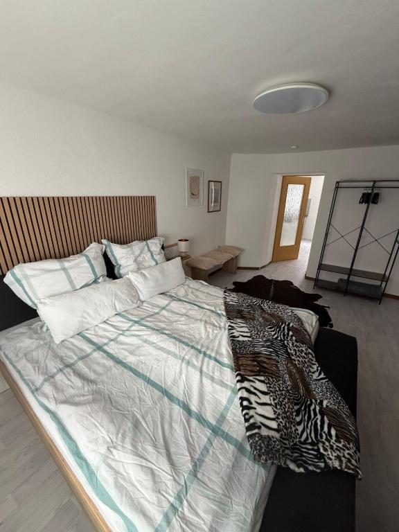 a bedroom with a large bed with a zebra blanket on it at Bella Vita Apartment due in Ediger-Eller