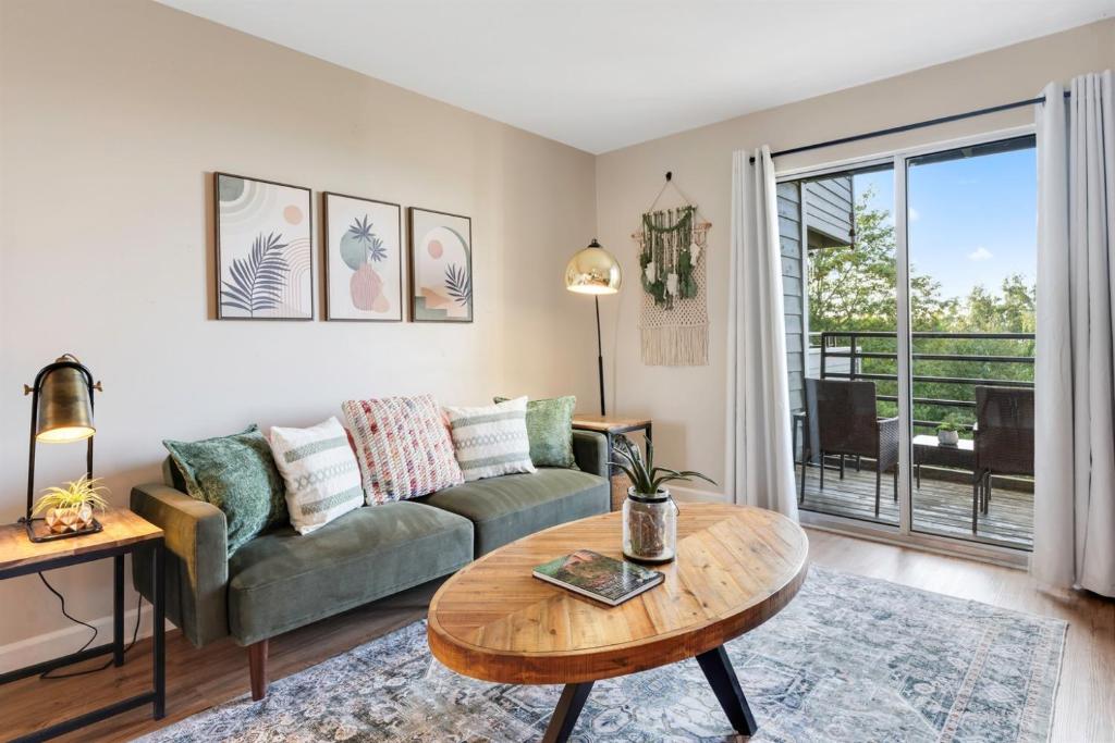 a living room with a couch and a table at Above the Trees - Modern Studio for 2 with Views, Wifi, Pools in Gatlinburg