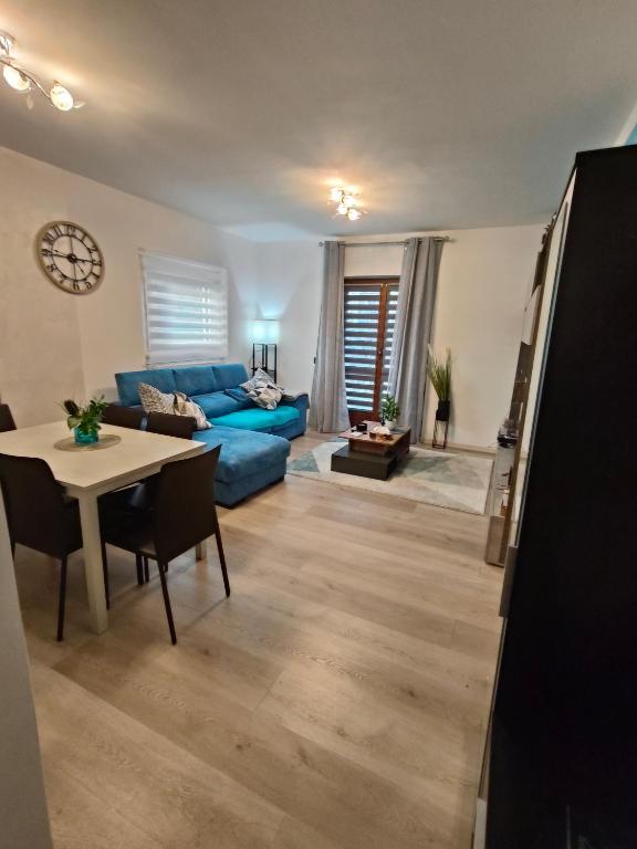 a living room with a blue couch and a table at Dimora di Teglio in Teglio