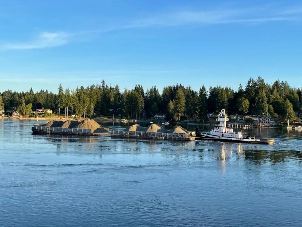 a boat is docked at a dock on the water at The Riptide Retreat in Shelton