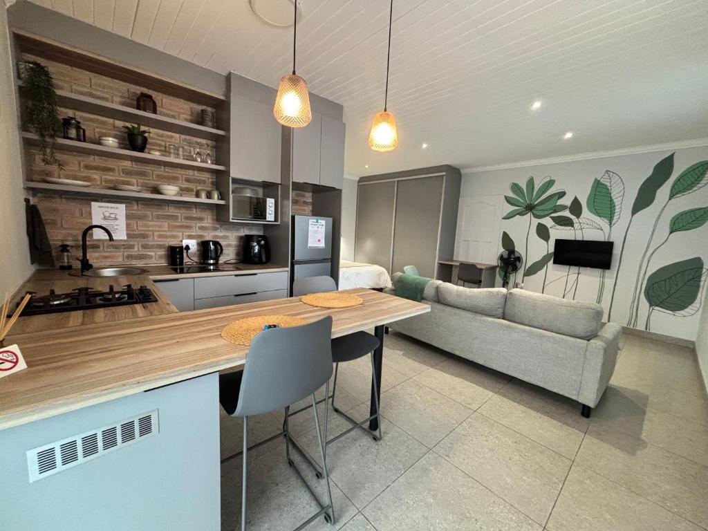 a kitchen and living room with a table and a couch at Prospect Cottage in Walmer