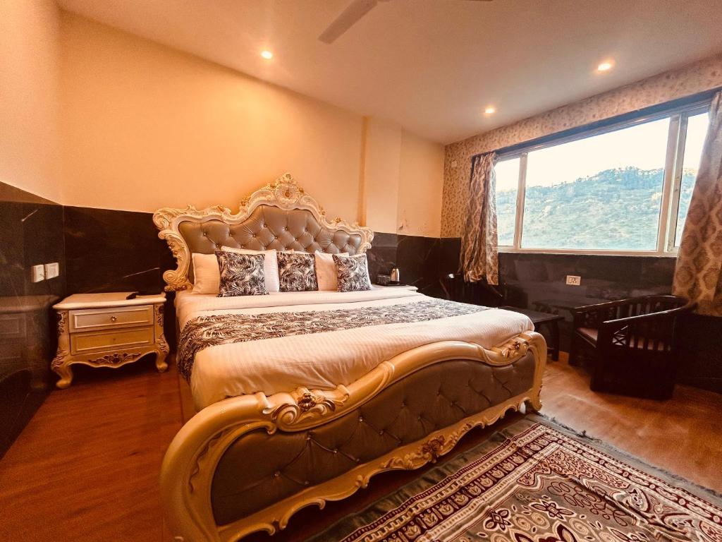 a bedroom with a large bed with a large window at Most Awarded Property In Mussoorie in Mussoorie