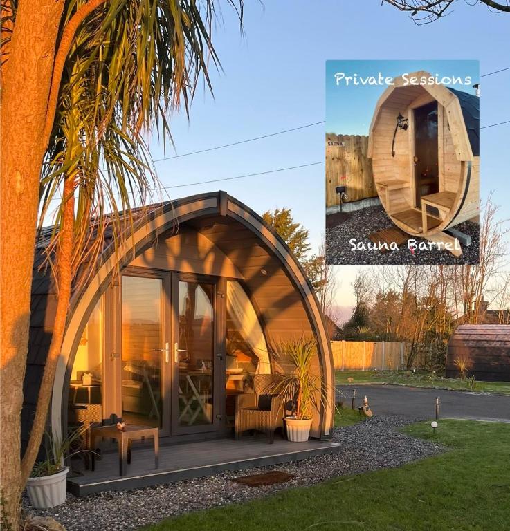 a round house with a curved roof in a garden at Copper Coast Glamping Pods - An Faoileán Pod in Bunmahon