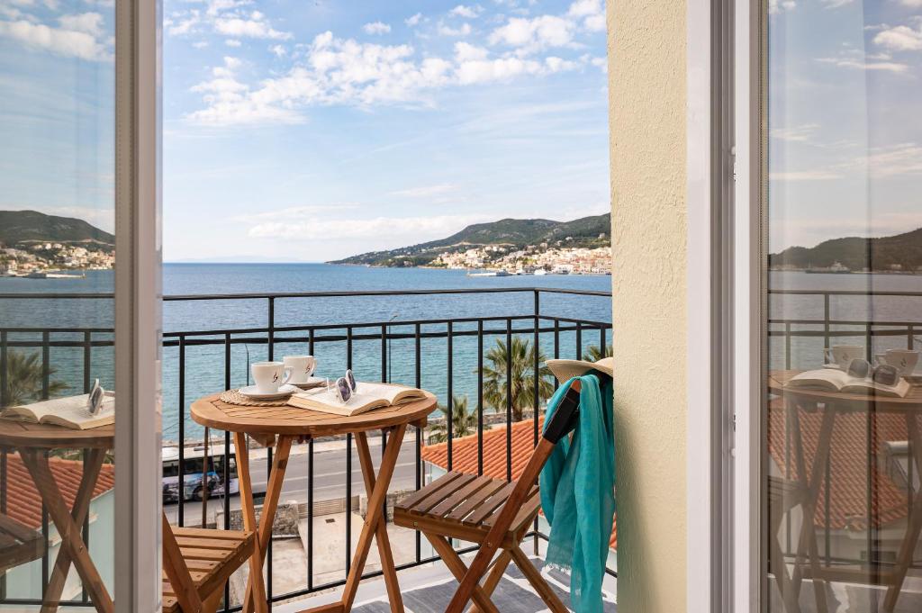a balcony with a table and chairs and a view of the ocean at SeaView City in Samos