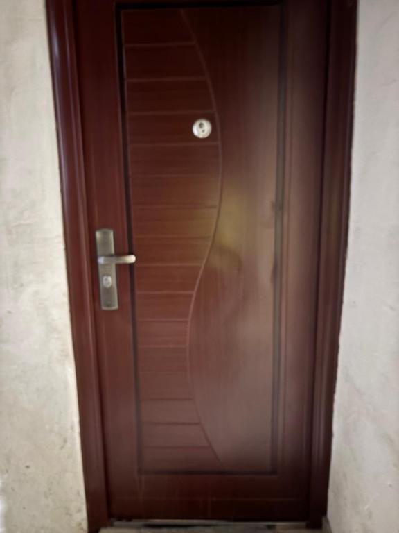 a wooden door with a reflection of a persons face at Hotel MANTASHOV in Meghri