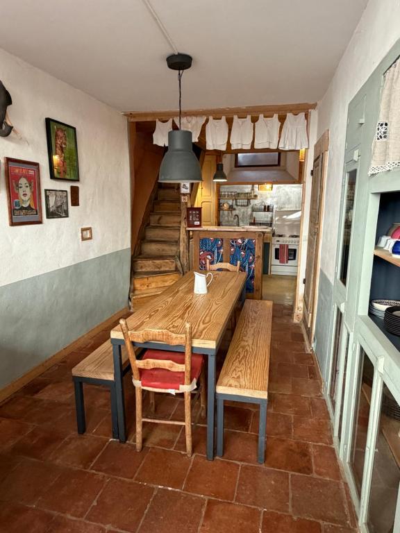 a dining room with a wooden table and chairs at File dans ta chambre ! in Le Monastier sur Gazeille