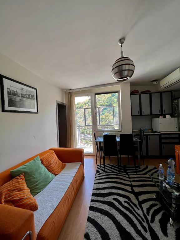 a living room with a couch and a dining room at Sheshi-Prizren in Prizren