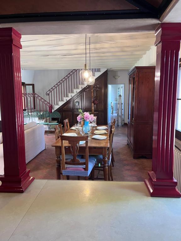 a dining room with a table and a staircase at Villa Riviera in Mira