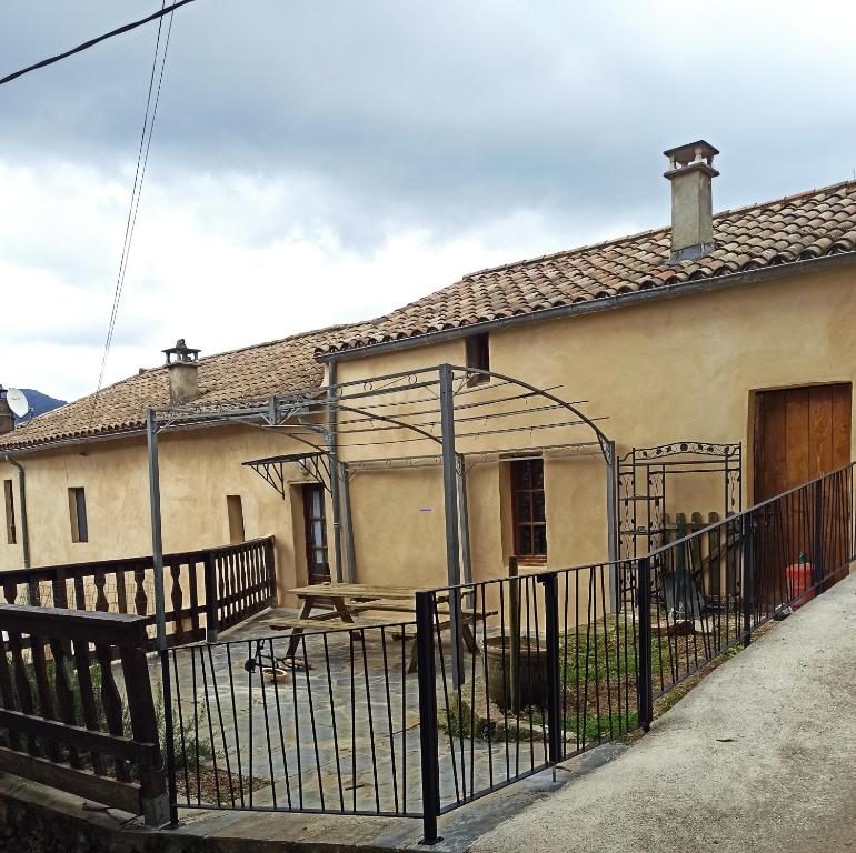 a house with a fence in front of it at Gite à Valleraugue Gard Cevennes in Valleraugue