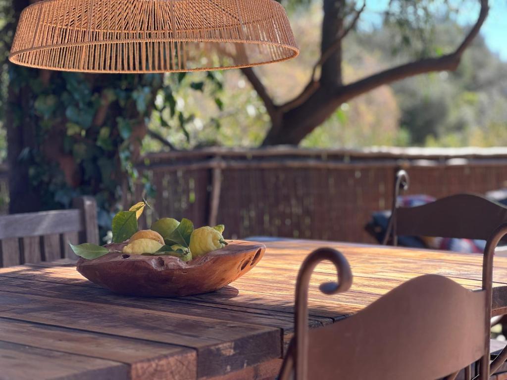 a bowl of fruit on a table with a lamp at Boutique Finca Stay in Nature in Mijas
