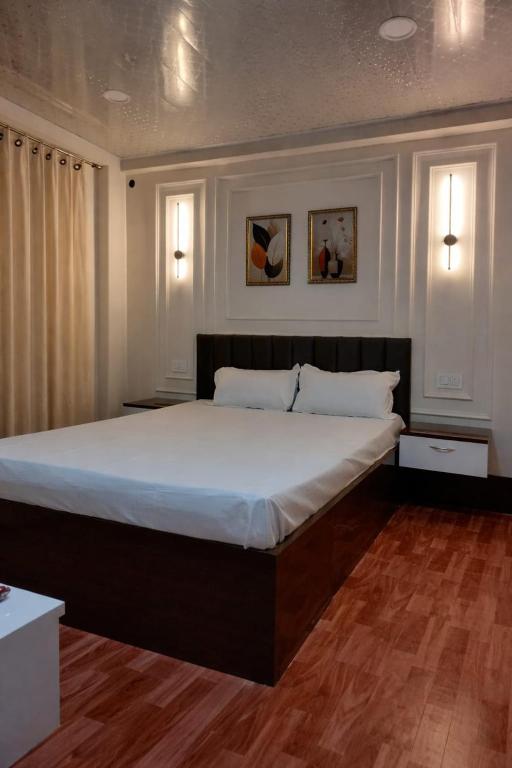 a large bed in a bedroom with two windows at Kadamba Bnb Homestay in Kurseong