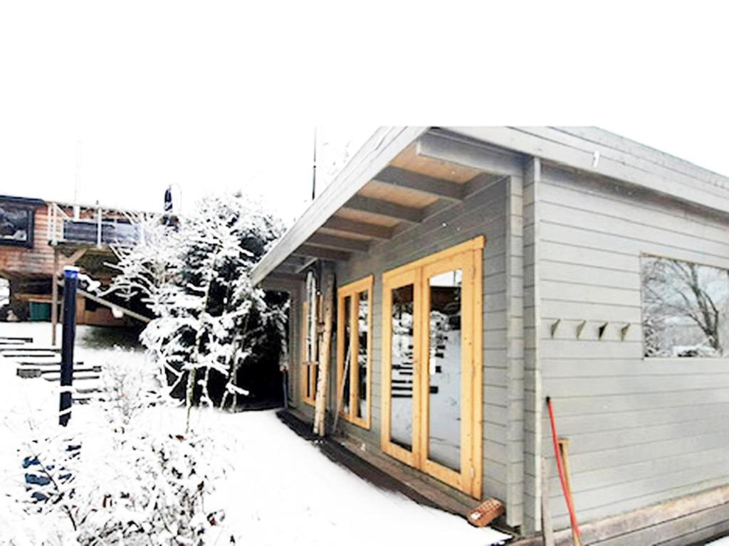 a small building with a door in the snow at Ferienhaus Allrode mit Wellness in Allrode