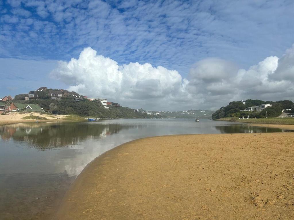 a body of water with houses on the shore at Rivers Rest in Seafield