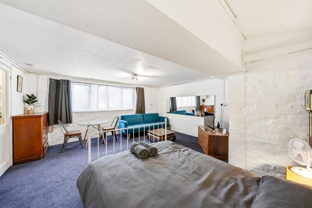 a bedroom with a bed and a living room at Lee Valley Lodge Ground Floor in Cheshunt