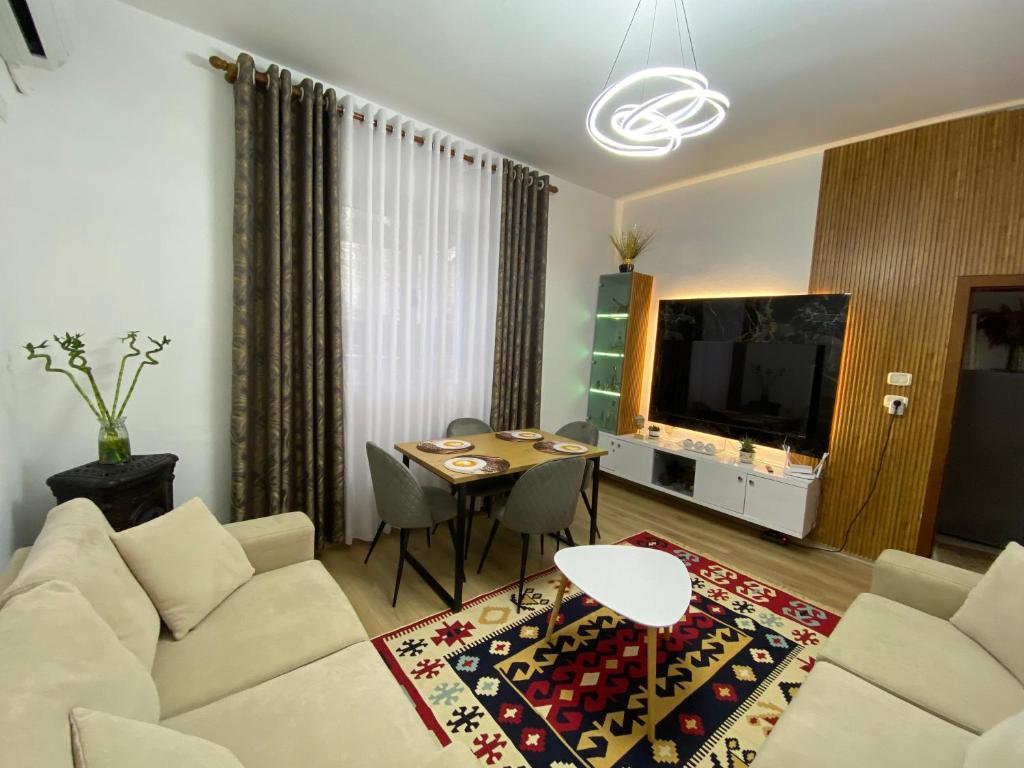 a living room with a couch and a table at Guest House Brahimasi in Çorovodë