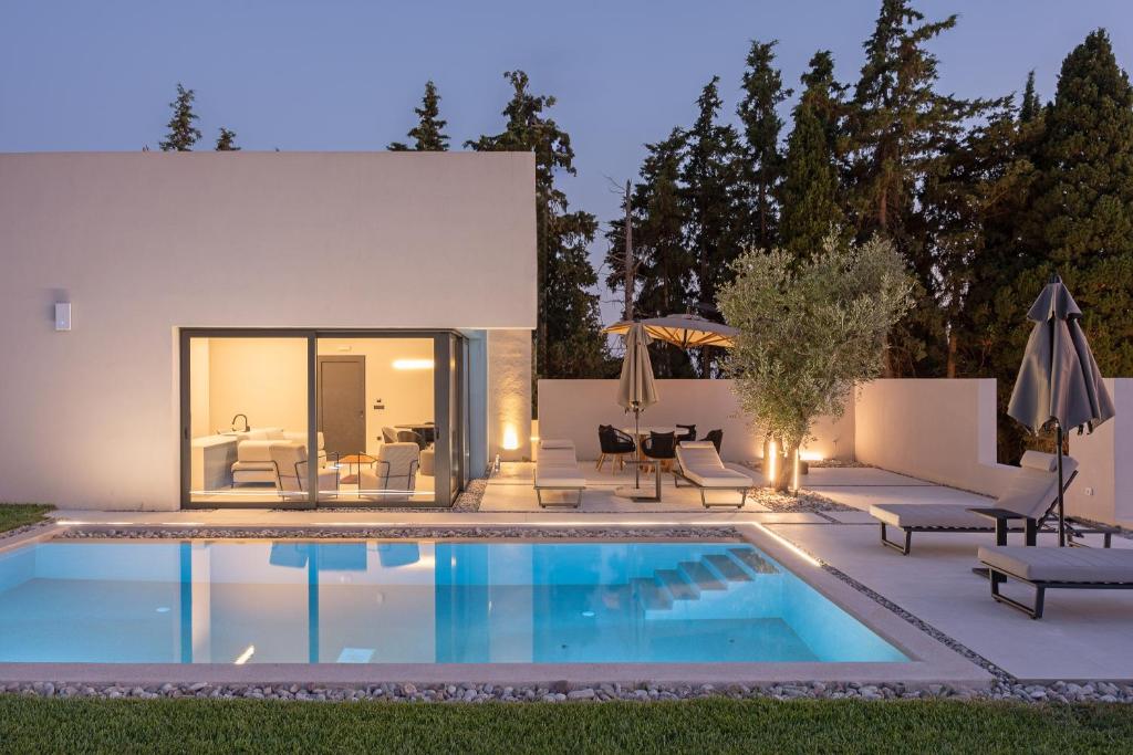 a swimming pool in the backyard of a house at Black Mountain Villas in Kefallonia