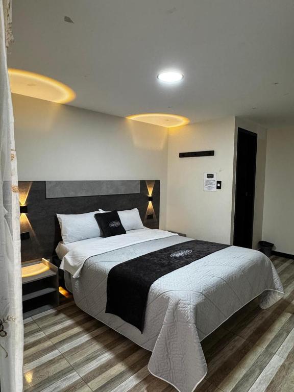 a bedroom with a large bed in a room at Hotel San Alejo in Ipiales