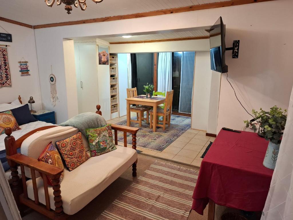 a living room with a couch and a table at 65 Rowweklip in Jongensfontein