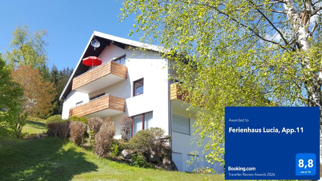 a building with a sign in front of it at Ferienhaus Lucia, App.11 in Schönwald