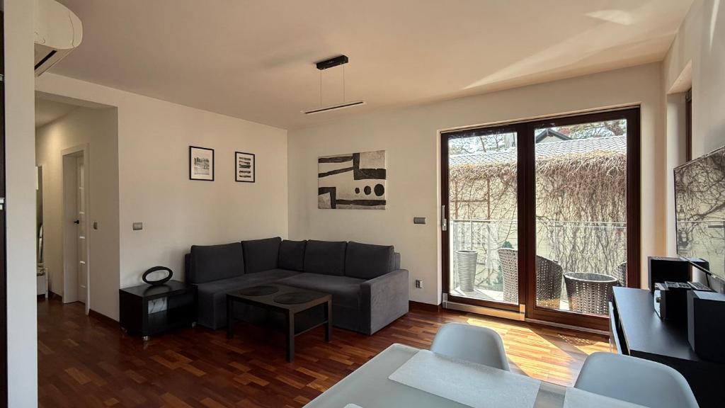 a living room with a couch and a large window at Aqua Villa 4 in Jurata