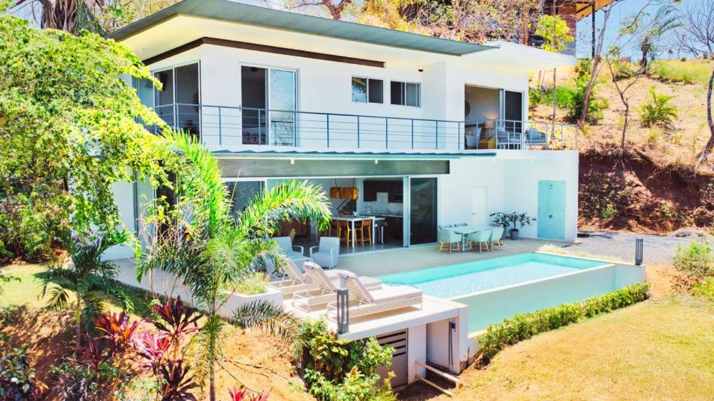 a villa with a swimming pool and a house at Ocean View Tranquility 2BR with Pool in San Juanillo