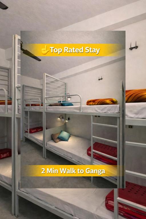 a set of three bunk beds in a room at Art Bliss Rishikesh - Yoga Hostel & Café in Rishīkesh