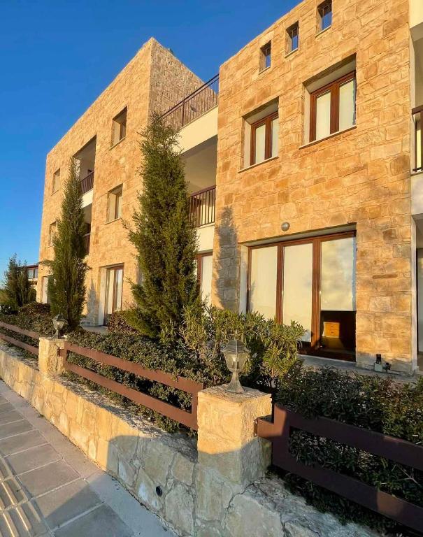 a large brick building with a glass trophy in front of it at Daniel's Hotel Apartments in Paphos