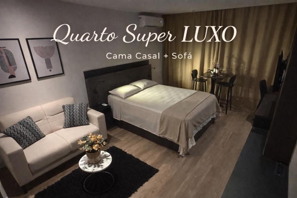 a living room with a bed and a couch at América Executive Apart Hotel Campos - LAMAG in Campos dos Goytacazes