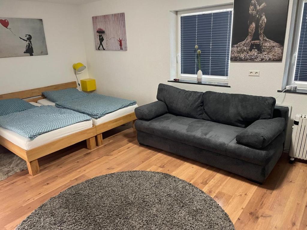 a living room with a couch and a bed at Altes Vogtshaus in Weil am Rhein