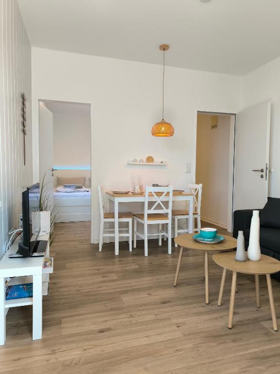 a living room with a table and a dining room at Wind und Meer in Langeoog