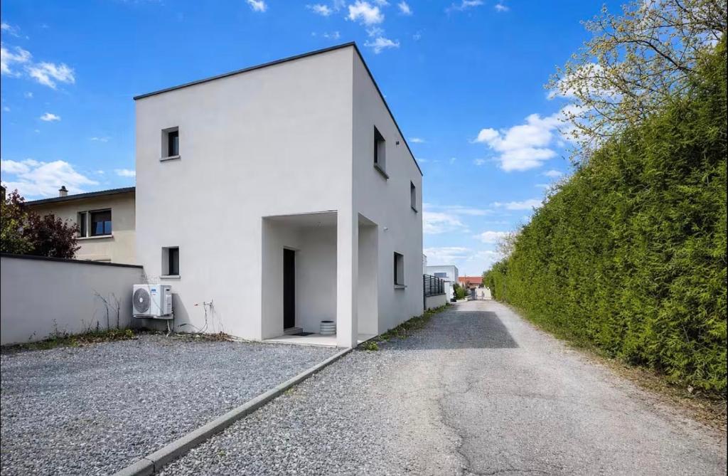 a white building on the side of a road at villa sam in Feyzin