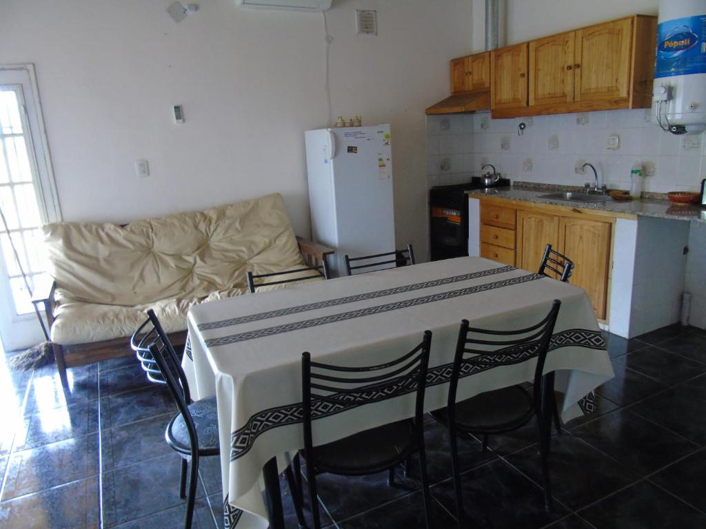 a kitchen with a table and chairs and a couch at Lucy Sol Cabañas in San Rafael