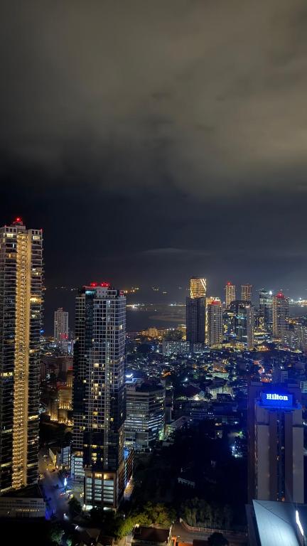 a city skyline at night with lit up buildings at Luxury Trizen Aki Apartments in Colombo