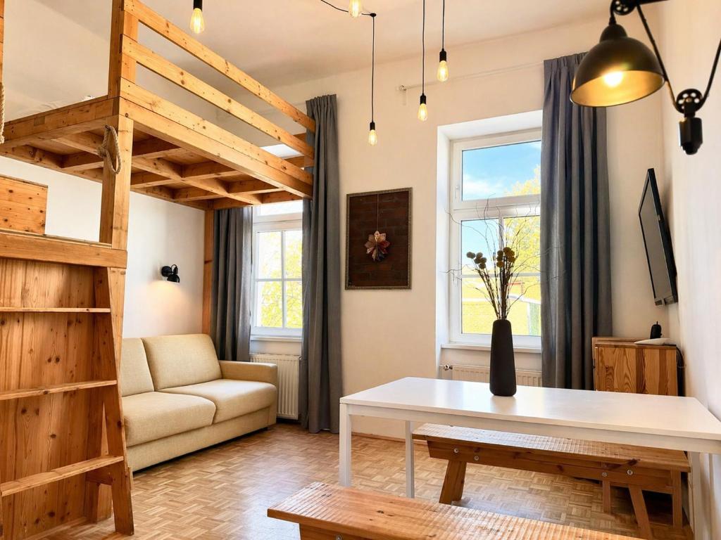 a living room with a loft bed and a table at Urban by BestChoice - FREE Parking - Self Check-in in Graz