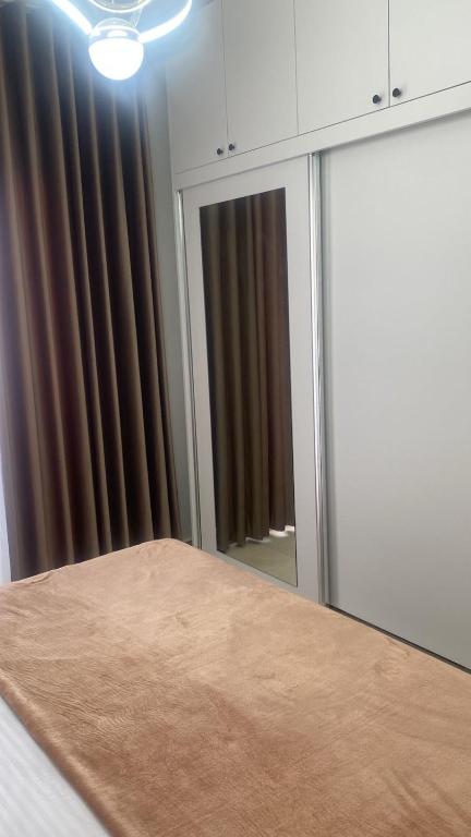 a room with a mirror and a table in front of a window at Golem luxury apartment in Golem