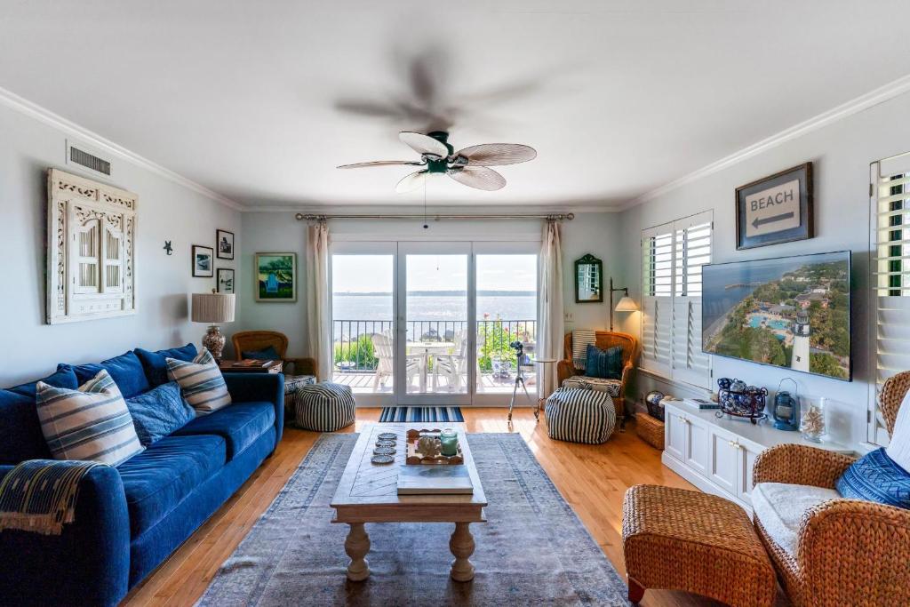 a living room with a blue couch and a table at Pier Pointe #101 - 100 Floyd Street, Unit 101 in Saint Simons Island