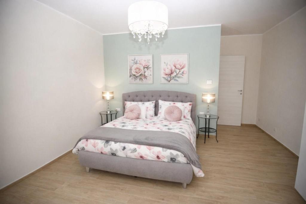 a bedroom with a bed and two pictures on the wall at Al Tredici in Ardea