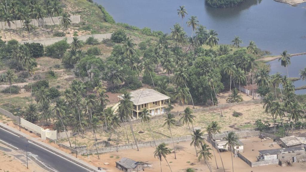 an aerial view of a house on a hill with palm trees at Laguna Lodge in Ouidah