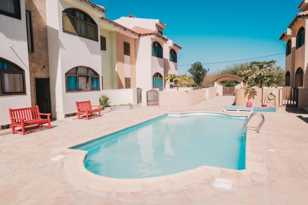 a swimming pool in a courtyard with a house at Carla Tryana Fernandes Castro in Vila do Porto