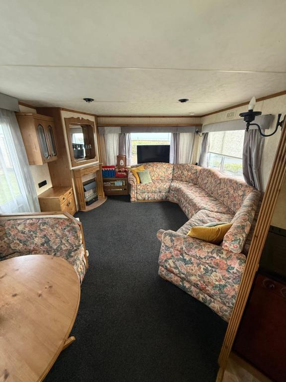 a living room in an rv with a couch at Holiday Home Arbroath in Arbroath