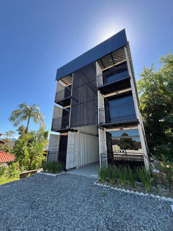 an apartment building with balconies on the side of it at Studio Garten Container in Joinville