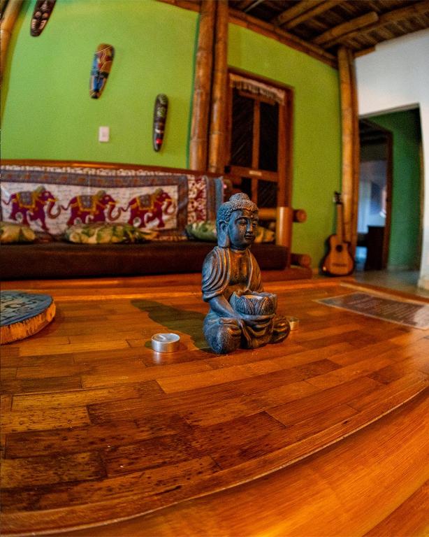 a small statue sitting on the floor of a room at Hostal Corazón de Tagua in Palomino