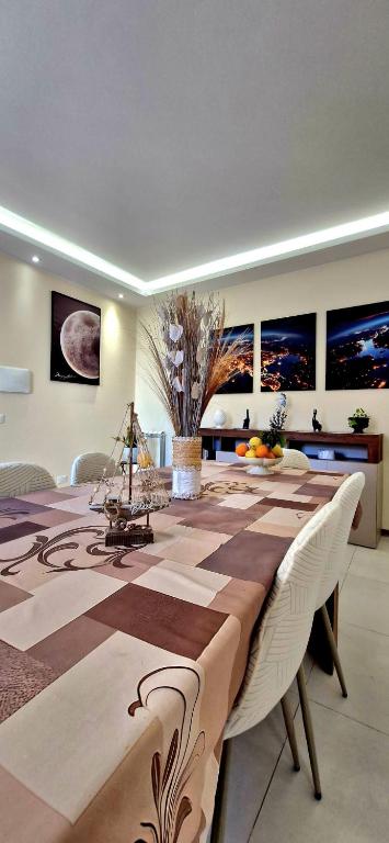a dining room with a long table with chairs at IVAN house - TERRASINI SICILIA in Terrasini