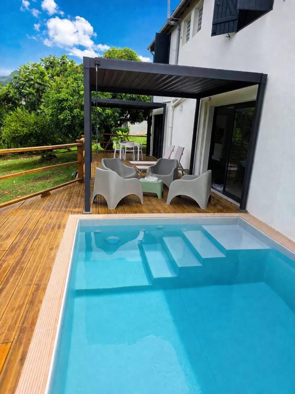 a swimming pool in the backyard of a house at Kaloukera in Trois-Rivières