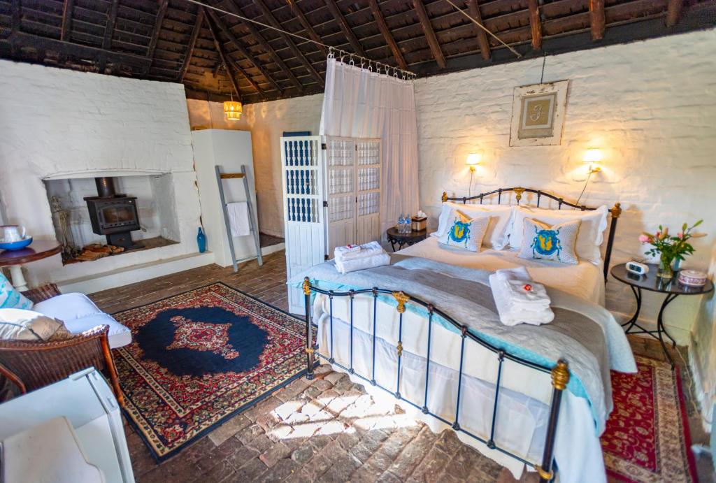 a bedroom with a bed in a room with a fireplace at The Globe Inn in Yass